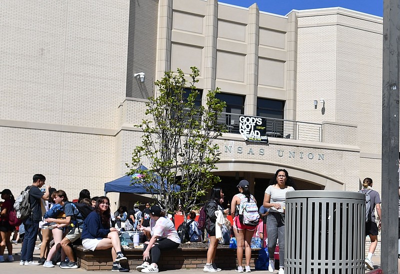 Students are shown on the Arkansas Union Mall outside the Arkansas Union on the campus of the University of Arkansas, Fayetteville in this April 12, 2023 file photo. (NWA Democrat-Gazette/Andy Shupe)