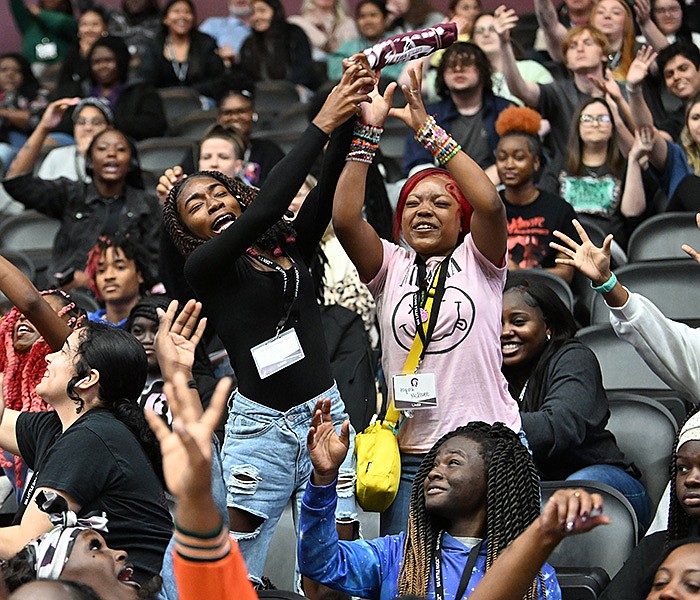 High school students reach for thrown T-shirts following the announcement of the new Trojan Guarantee program Wednesday during the Discover college preview day at the University of Arkansas at Little Rock’s Jack Stephens Center.
(Arkansas Democrat-Gazette/Staci Vandagriff)