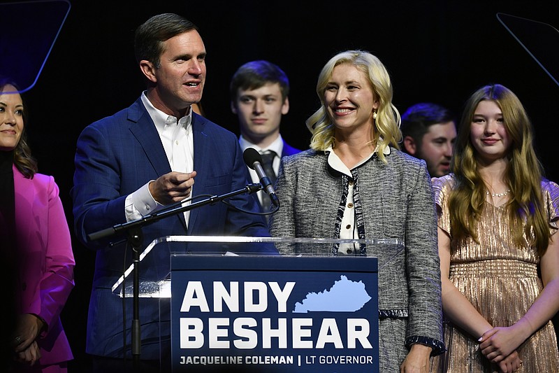 Kentucky Gov. Andy Beshear speaks during an election night rally after he was elected to a second term in Louisville, Ky., Tuesday, Nov. 7, 2023. At right is his wife Britainy Beshear. (AP Photo/Timothy D. Easley)