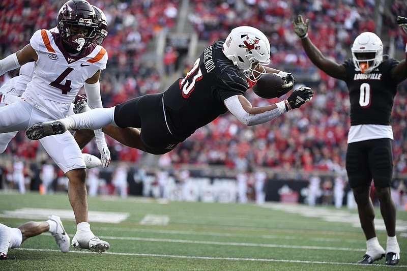 Louisville running back Isaac Guerendo (23) saves into the end zone during the second half of an NCAA college football game in Louisville, Ky., Saturday, Nov. 4, 2023. Louisville won 34-3. (AP Photo/Timothy D. Easley)