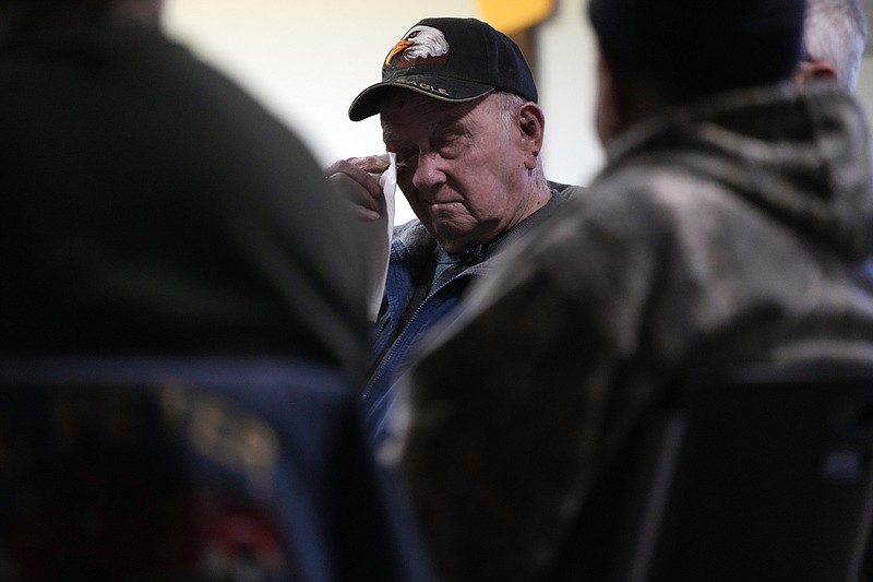 Earl Meyer, who fought for the U.S. Army in the Korean War, wipes away a tear while talking with fellow veterans at the American Legion, Tuesday, Nov. 7, 2023, in St. Peter, Minn. Meyer, 96, is suing the Army to try to get the Purple Heart medal that he says he earned when he was wounded during fierce combat in June of 1951. (AP Photo/Abbie Parr)