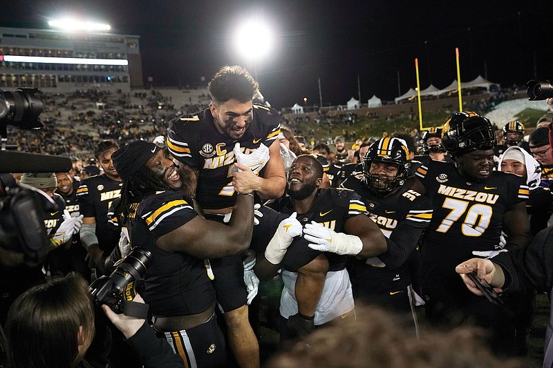 Missouri running back Cody Schrader is lifted by teammates following Saturday’s 36-7 win against Tennessee at Faurot Field in Columbia. (Associated Press)
