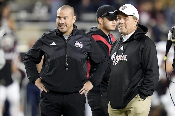 Texas A&M head coach Jimbo Fisher, right, talks with Mississippi State head coach Zach Arnett, left, before the start of an NCAA college football game Saturday, Nov. 11, 2023, in College Station, Texas. (AP Photo/Sam Craft)