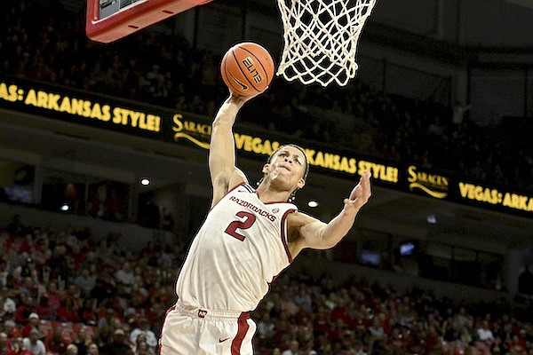 Arkansas forward Trevon Brazile dunks against Old Dominion defender during the second half of an NCAA college basketball game Monday, Nov. 13, 2023, in Fayetteville. (AP Photo/Michael Woods)