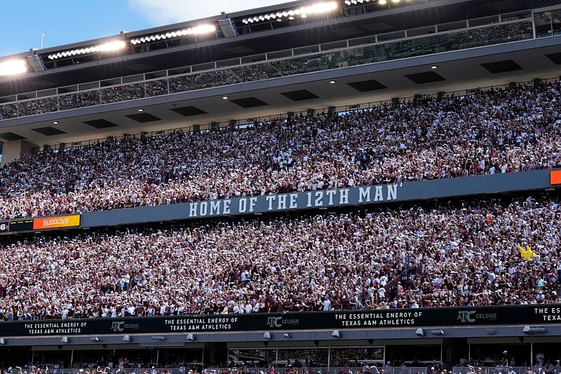 The student section of Kyle Field waves flags as the Texas A&M Aggies kick the ball off of against Auburn during the first half of an NCAA college football game Saturday, Sept. 23, 2023, in College Station, Texas. (AP Photo/Sam Craft)