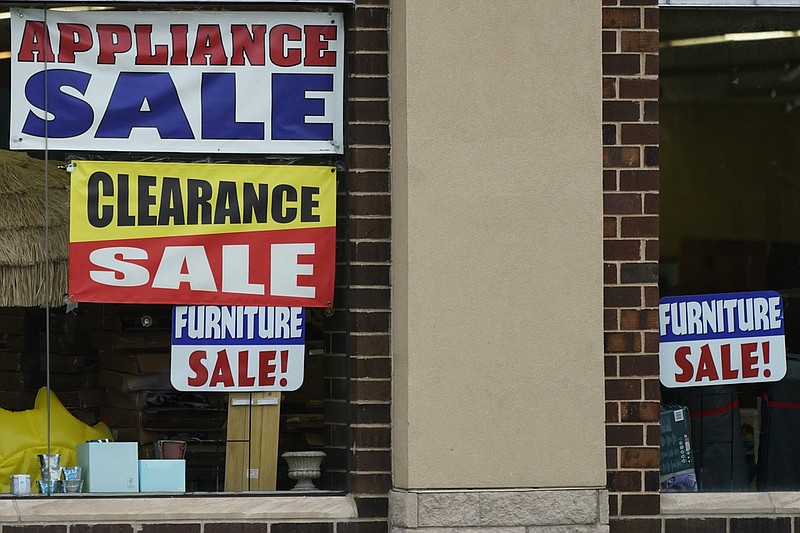 Sale signs are displayed at an appliance store in Arlington Heights, Ill., Wednesday, Nov. 8, 2023. (AP Photo/Nam Y. Huh)
