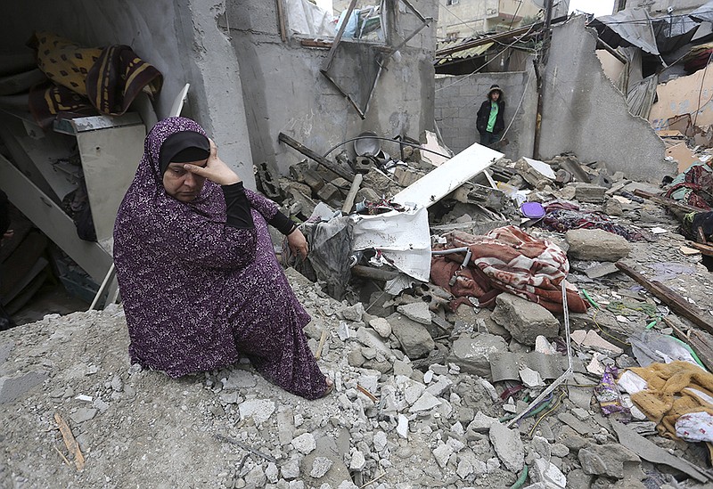 A Palestinian woman sits Wednesday amid destruction from Israeli strikes on Rafah, Gaza Strip.
(AP/Hatem Ali)