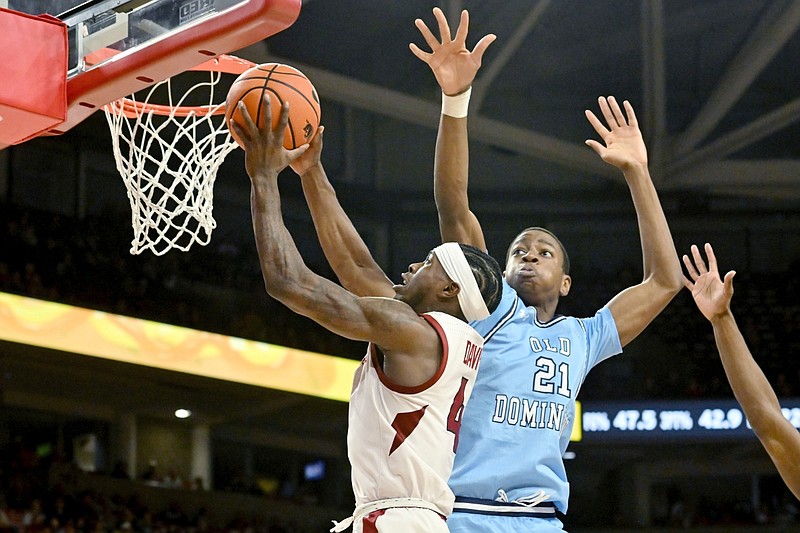 Arkansas guard Davonte Davis (4) drives past Old Dominion center Leeroy Odiahi (21) to score during the second half of an NCAA college basketball game, Monday, Nov. 13, 2023, in Fayetteville, Ark. (AP Photo/Michael Woods)
