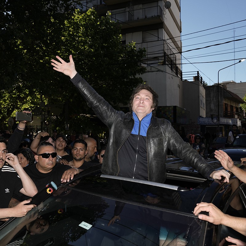 Presidential hopeful Javier Milei waves to supporters as he campaigns in Buenos Aires, Argentina, Monday, Nov. 6, 2023. Milei has gone from being a television talking head that garnered high ratings with his unrestrained outbursts against the "political caste" that he blamed for Argentina's perennial economic woes to a frontrunner for the presidency. A presidential runoff election is set for Nov. 19. (AP Photo/Rodrigo Abd)