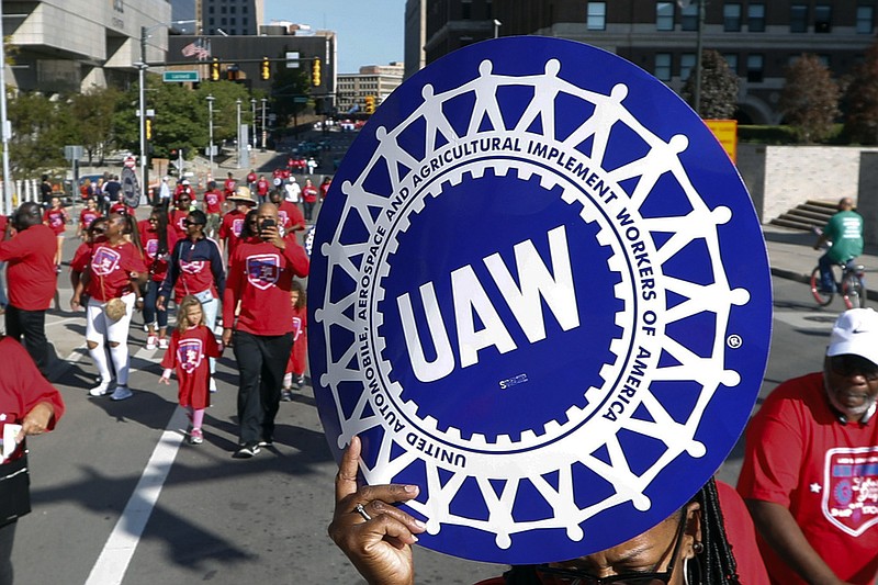 FILE - United Auto Workers members walk in the Labor Day parade in Detroit, Sept. 2, 2019. The tentative contract agreement between General Motors and the United Auto Workers union appears to be headed for defeat. The union hasn’t posted final vote totals yet, but workers at five large factories who finished voting in the past few days have turned down the four year and eight month deal by fairly large margins. (AP Photo/Paul Sancya, File)