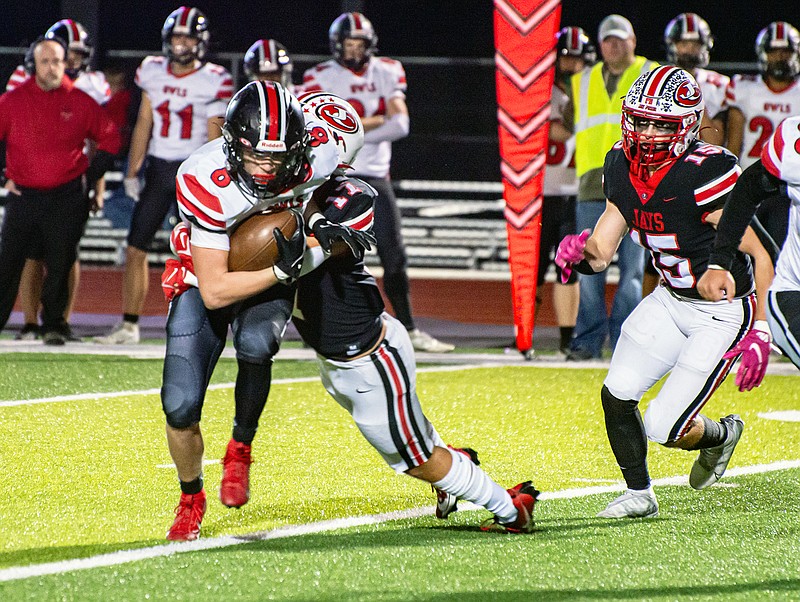 Jefferson City's Anthony Seneker drags down Marshall’s Jaxson Case during the Class 4 District 5 semifinal game earlier this month at Adkins Stadium. (Ken Barnes/News Tribune)