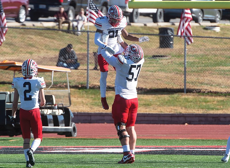 Jefferson City’s Brody Smith lifts up Bradarious Lewis after a touchdown run during Saturday afternoon’s Class 4 state quarterfinal game against McDonald County in Anderson. (Roger Nomer/Joplin Globe)