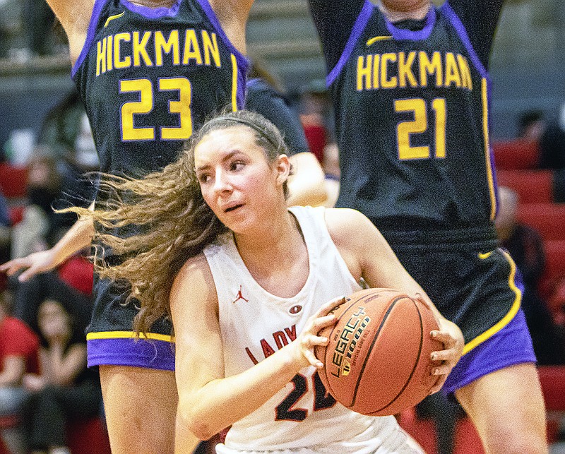 Jefferson City's Bri Avey looks to pass the ball while being guarded by a pair of Hickman defenders during a game last season at Fleming Fieldhouse. (News Tribune file photo)