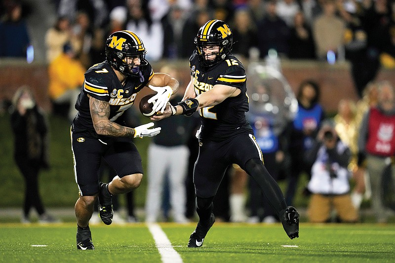 Missouri quarterback Brady Cook hands off to running back Cody Schrader during last Saturday night’s game against Florida at Faurot Field in Columbia. (Associated Press)