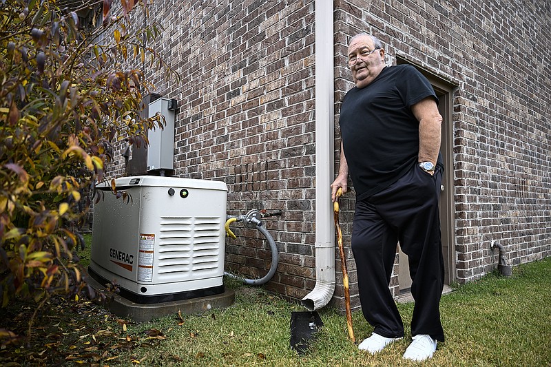 Michael Bauer stands near a generator he had installed outside his house in West Little Rock because of frequent power outages on Monday, Nov. 20, 2023. ..(Arkansas Democrat-Gazette/Stephen Swofford)
