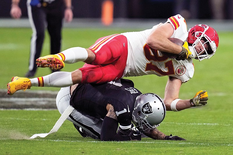 Chiefs tight end Travis Kelce is tackled by Raiders safety Marcus Epps during the second half of Sunday’s game in Las Vegas. (Associated Press)