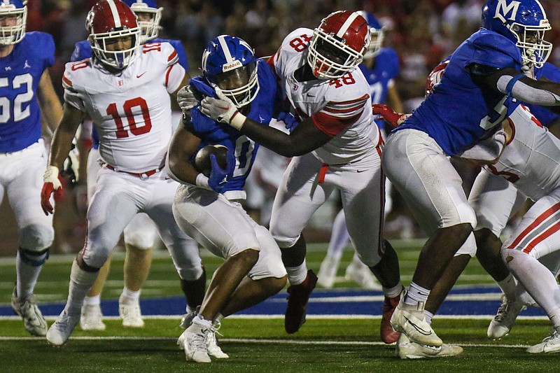 Staff photo by Olivia Ross / McCallie’s Javon McMahan (0) attempts to get past Baylor’s John Amofah Jr. (48) September 29. The Blue Tornado and Red Raiders will meet again Thursday to decide the TSSAA DII-AAA championship at Finley Stadium.
