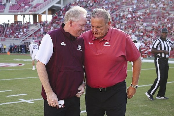 Arkansas coach Sam Pittman (right) and Missouri State coach Bobby Petrino are shown prior to a game Saturday, Sept. 17, 2022, in Fayetteville.
