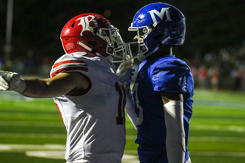 Staff photo by Olivia Ross / Baylor’s Nelson McKnight (16) and McCallie’s Carson Lawrence (3) talk to each other following Lawrence’s touchdown. McCallie took on Baylor at home on Friday, September 29, 2023.