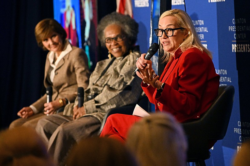 Stephanie Streett (from right), executive director of the Clinton Foundation, speaks as Sharon Farmer, former White House photographer and Capricia Marshall, former White House social secretary, look on Friday during opening night of the “Be Our Guest” exhibit at the Clinton Presidential Center in Little Rock.
(Arkansas Democrat-Gazette/Staci Vandagriff)