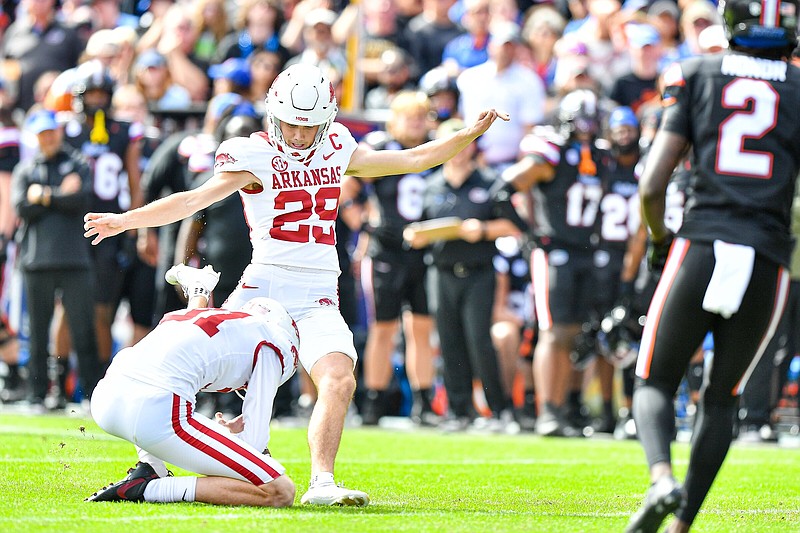 Arkansas kicker Cam Little (29) makes a 41-yard field goal as punter Max Fletcher (31) holds Nov. 4 during a 39-36 overtime win over Florida at Ben Hill Griffin Stadium in Gainesville, Fla. Little announced Friday he will declare for the NFL Draft.
(NWA Democrat-Gazette/Hank Layton)
