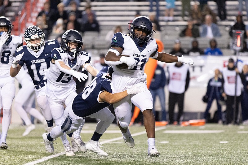 Little Rock Christian running back Conner Smith (right) is brought down by Greenwood defensive back Josh Allen during Friday night’s game.
(Arkansas Democrat-Gazette/Justin Cunningham)