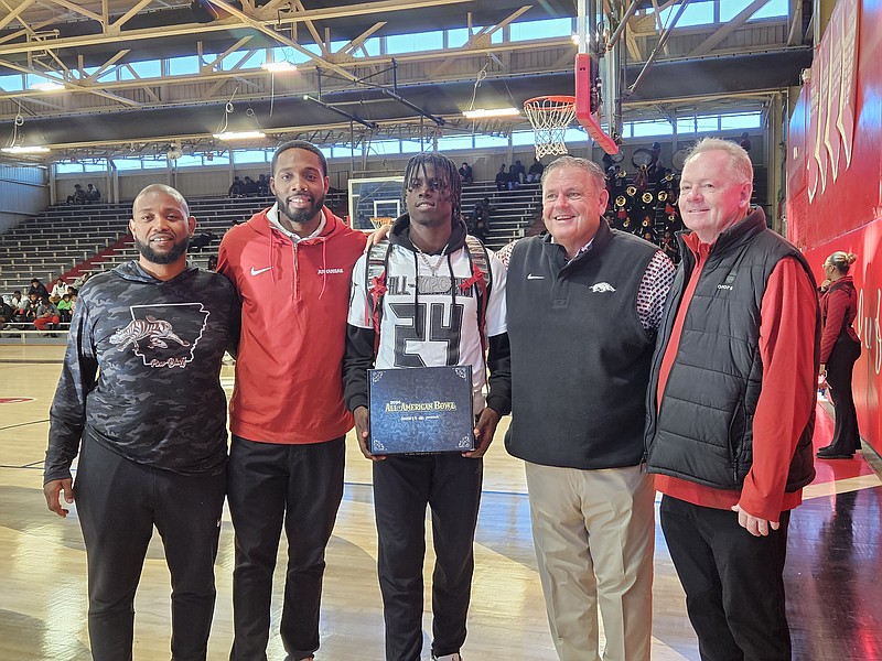 Pine Bluff senior Courtney Crutchfield received his All-American Bowl jersey Friday afternoon. L to R: PBHS head football coach Micheal Williams, Arkansas wide receivers coach Kenny Guiton, Courtney Crutchfield, Arkansas head coach Sam Pittman, Arkansas offensive coordinator Bobby Petrino. (Pine Bluff Commercial/Tanner Spearman)