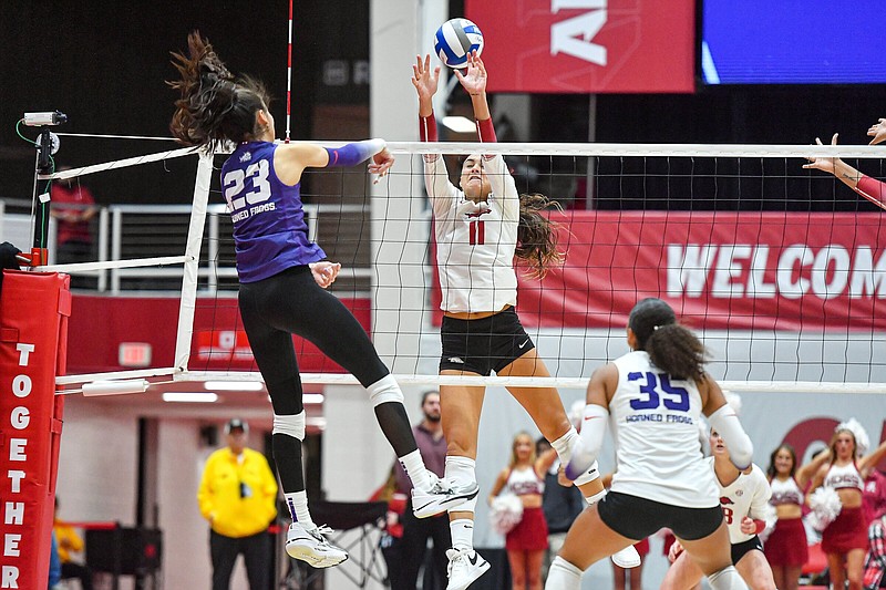 Arkansas outside hitter Maggie Cartwright (11) attempts to block a spike by TCU outside hitter Melanie Parra (23), Saturday, Dec. 2, 2023, during the third set against the Horned Frogs in the second round of the NCAA Women’s Volleyball Championship at Barnhill Arena in Fayetteville. Visit nwaonline.com/photo for today's photo gallery..(NWA Democrat-Gazette/Hank Layton)