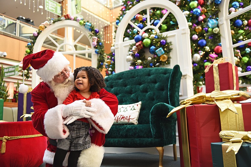 Santa Claus visits with Selah Kumwenda, 3, during the Sensory Santa event Sunday at the Park Plaza mall in Little Rock..(Arkansas Democrat-Gazette/Staci Vandagriff)
