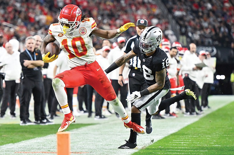 Chiefs running back Isiah Pacheco is pushed out of bounds by Raiders cornerback Jack Jones during last Sunday’s game in Las Vegas. (Associated Press)