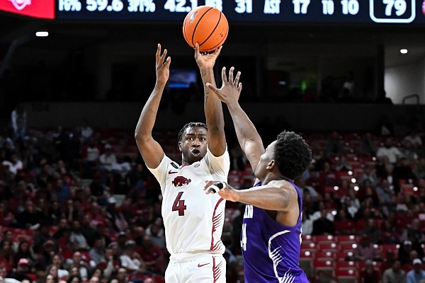 Davonte Davis (4) shoots the ball in the second half on Monday, Dec. 4, 2023, at Bud Walton Arena in Fayetteville. Visit nwaonline.com/photo for the photo gallery. (NWA Democrat-Gazette/Caleb Grieger)