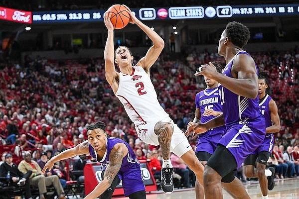 Arkansas' Trevon Brazile (2) goes up for a shot during a game against Furman on Monday, Dec. 4, 2023, in Fayetteville. (Caleb Grieger/NWA Democrat-Gazette)
