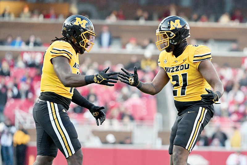 Missouri teammates Johnny Walker Jr. (left) and Nyles Gaddy celebrate after a big play during last month’s game against Arkansas in Fayetteville, Ark. (Associated Press)