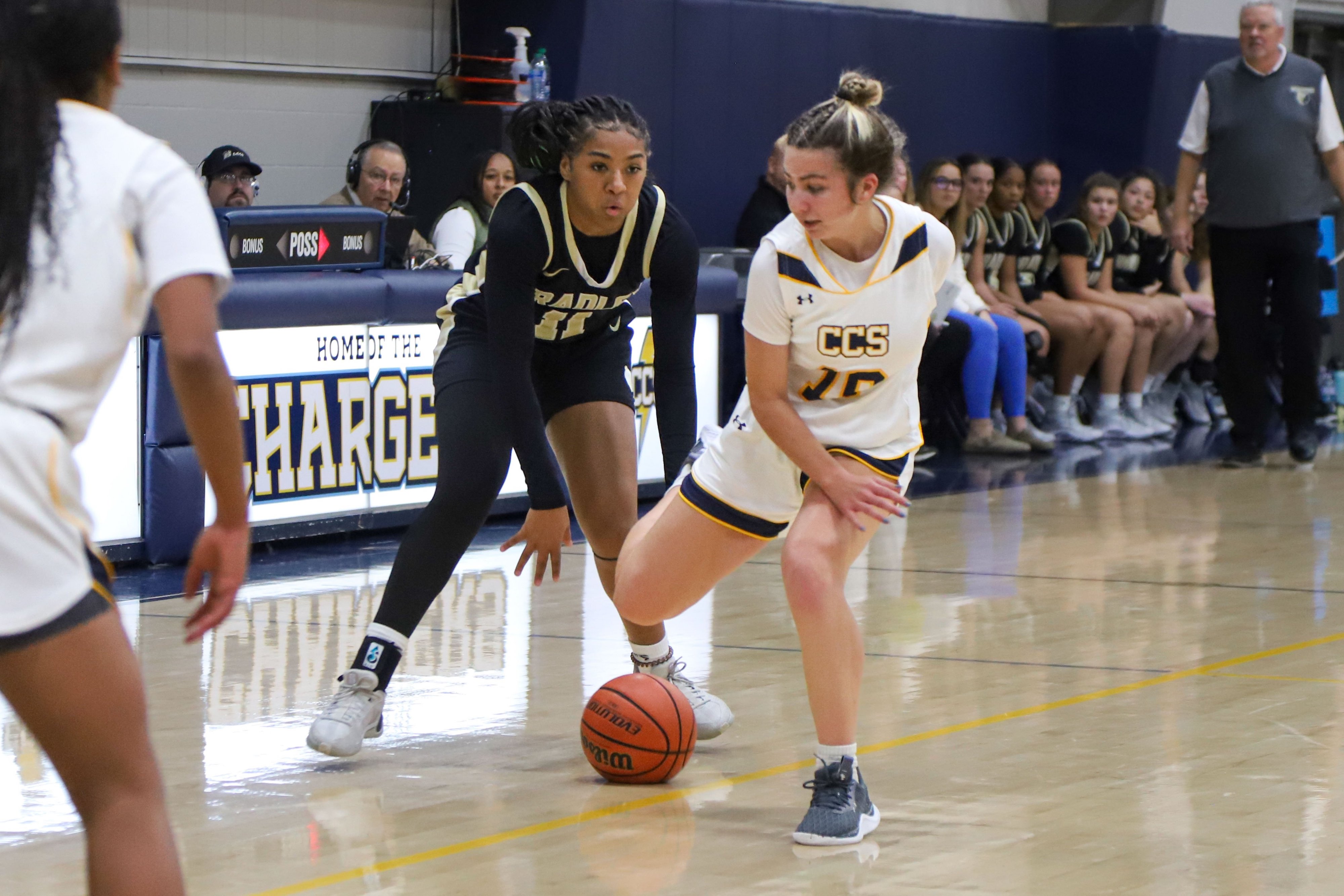 Staff photo by Olivia Ross / Bradley’s Harmonie Ware (11) dribbles the ball toward the net, guarded by CCS’s Tess Duble (10). Chattanooga Christian took on Bradley Central at home on Tuesday, December 5, 2023.