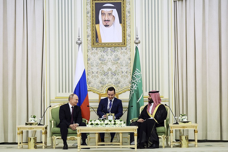Saudi Crown Prince Mohammed bin Salman (right) and Russian President Vladimir Putin attend talks at the Al Yamamah Palace in Riyadh, Saudi Arabia, on Wednesday. At top is a picture showing Saudi King Salman.
(AP/Kremlin/Sputnik/Sergei Savostyanov)