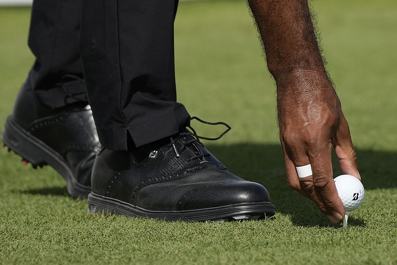 AP photo by Fernando Llano / Tiger Woods places his golf ball on the first tee during last Thursday's opening round of the Hero World Challenge at Albany Golf Club in the Bahamas. The USGA and the R&A announced their joint decision Wednesday that will eventually roll back the distance golf balls travel.
