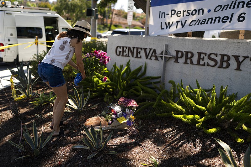 Joanna Garcia leaves flowers outside Geneva Presbyterian Church in Laguna Woods, Calif., in this May 16, 2022 file photo. Authorities said at the time that the gunman in a deadly attack at the church one day earlier was a Chinese immigrant motivated by hate for Taiwanese people. (AP/Jae C. Hong)