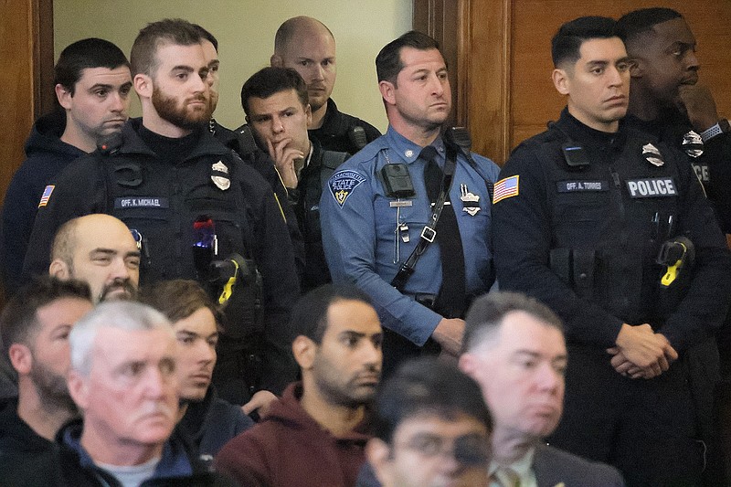 An overflow crowd of families, police, and utility workers fill the court in Waltham, Mass., Thursday, Dec. 7, 2023. Peter Simon was arraigned in Waltham District Court on a litany of charges including manslaughter in the traffic deaths of police officer Paul Tracey and a National Grid worker. (Lane Turner/The Boston Globe via AP, Pool)