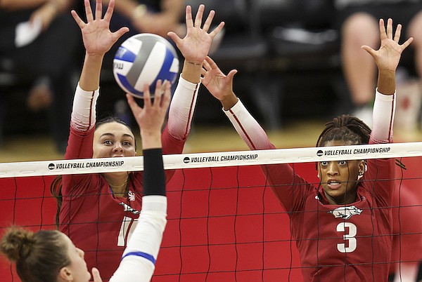 Arkansas' Maggie Cartwright (11) and Sania Petties (3) go up to block against Kentucky's Brooklyn DeLeye (17) during the third set of an NCAA women's college volleyball tournament match Thursday, Dec. 7, 2023, in Lincoln, Neb. (Nikos Frazier/Omaha World-Herald via AP)