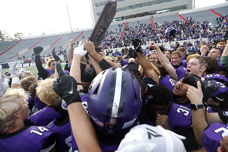 Fayetteville players celebrate the Purple Dogs’ 22-16 win over Bentonville in the Class 7A state championship game on Saturday, Dec. 2, 2023, at War Memorial Stadium in Little Rock. .More photos at www.arkansasonline.com/123state7a23/.(Arkansas Democrat-Gazette/Thomas Metthe)