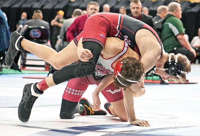 Jefferson City's Eli Teiberis (top) takes on Warrenton’s Noah Lohrmann during their fifth-place match at 126 pounds in last season’s Class 3 boys wrestling state championships at Mizzou Arena in Columbia. (News Tribune file photo)