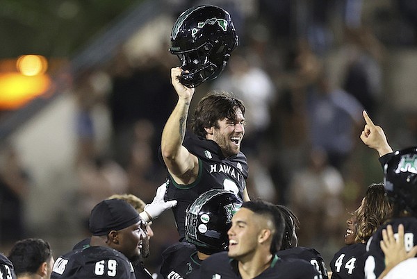 Hawaii place kicker Matthew Shipley (2) is carried by teammates after he kicked a last second, 51-yard field goal against Colorado State on Saturday, Nov. 25, 2023, in Honolulu. Hawaii defeated Colorado State 27-24. (AP Photo/Marco Garcia)