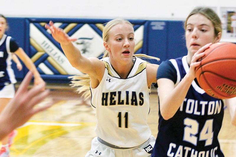 Kenadi Harrison of Helias guards Father Tolton's Hannah Cox during Tuesday night’s game at Rackers Fieldhouse. (Alexa Pfeiffer/News Tribune)