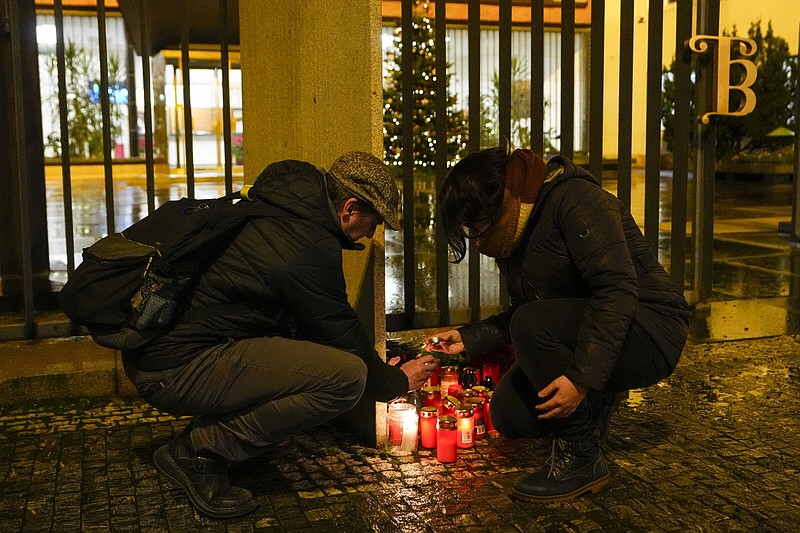 A woman lights candles outside of Charles University in downtown Prague, on Thursday.
(AP/Petr David Josek)