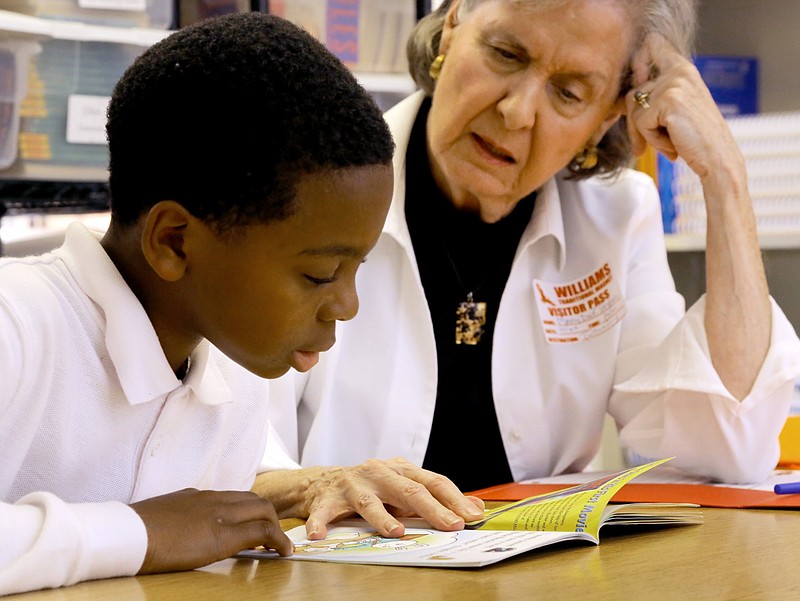 Braylon Maris, then a third-grade student at Williams Magnet Elementary in Little Rock, works on his literacy skills with the help of tutor Mary Dee Taylor in this Oct. 29, 2015 file photo. (Arkansas Democrat-Gazette file photo)
