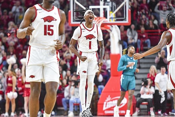 Arkansas guard Keyon Menifield (1) celebrates during the first half of a game against North Carolina-Wilmington on Saturday, Dec. 30, 2023, at Bud Walton Arena in Fayetteville.