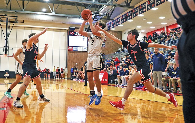 Sam Lopez of Helias shoots a jumper as Jefferson City's Rowen Buffington (1) defends during Friday's fifth-place game of the Joe Machens Great 8 Classic at Fleming Fieldhouse. (Jason Strickland/News Tribune)