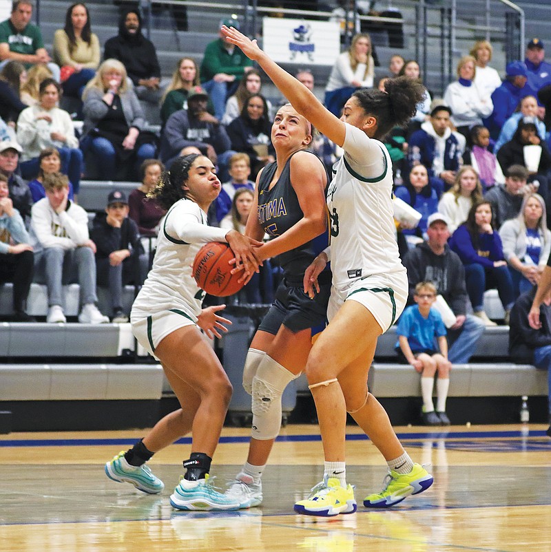 Fatima’s Alli Robertson attempts tp split the defense of Staley teammates Brielle Mays (left) and Ava Miles on Friday during the championship game of the Jefferson Bank Holiday Hoops Classic at Capital City High School. (Jason Strickland/News Tribune)