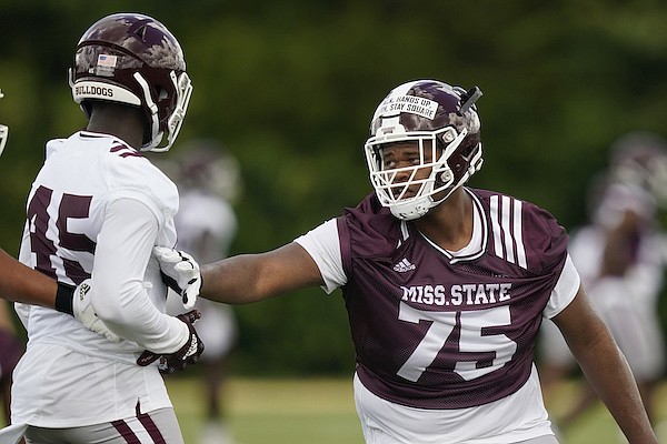 Mississippi State offensive lineman Percy Lewis (75) blocks linebacker Ty Cooper (45) during the NCAA college football team's practice Friday, Aug. 5, 2022, in Starkville, Miss. (AP Photo/Rogelio V. Solis)