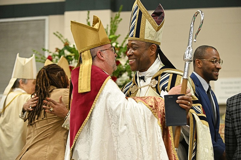 Bishop Suffragan Jeff Fisher (left) of Texas, vice president of Province VII of the Episcopal Church, embraces John Toga Wea Harmon during Harmon’s ordination and consecration at the Episcopal Collegiate School in Little Rock on Saturday, Jan. 6, 2024. Province VII comprises 11 dioceses across seven states, including Arkansas and Texas. (Arkansas Democrat-Gazette/Staci Vandagriff)